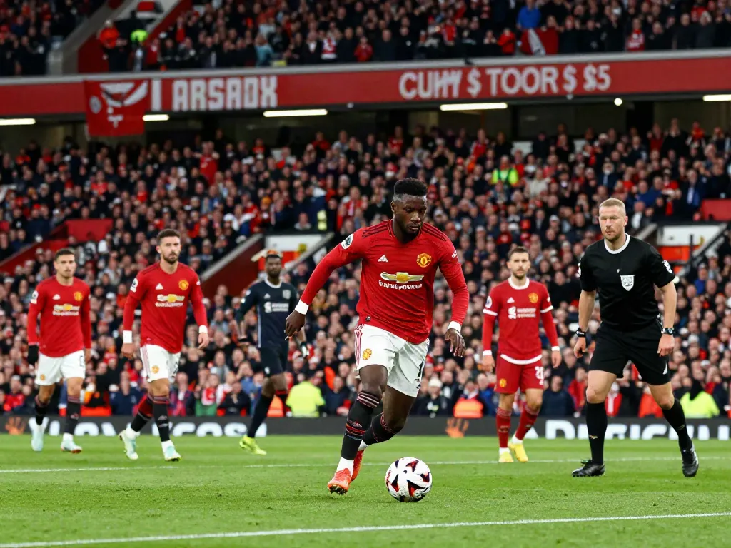 Intense match moment capturing Manchester United vs Liverpool rivalry on the field with players in action.